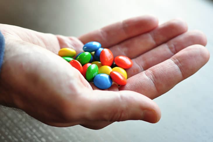 hand with m&m candy